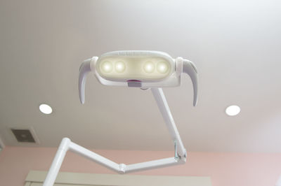 Close-up of illuminated lighting equipment in hospital