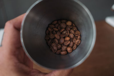 High angle view of hand holding coffee cup