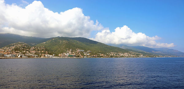 Panoramic view of sea and mountains against sky