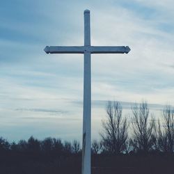 Low angle view of cross against sky