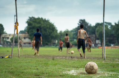 People playing soccer ball on field