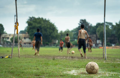 People playing soccer on field