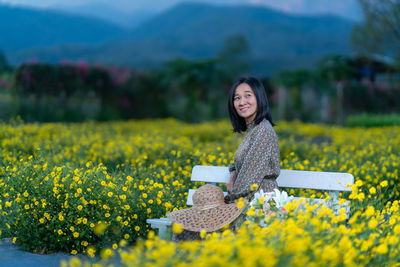 Portrait of a smiling young woman on field