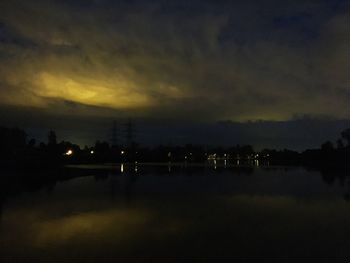 Scenic view of lake against sky at night