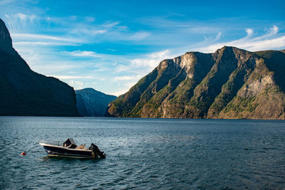 Scenic view of sea and mountains against sky