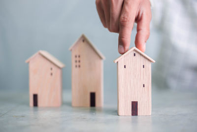 Hand holding toy against house