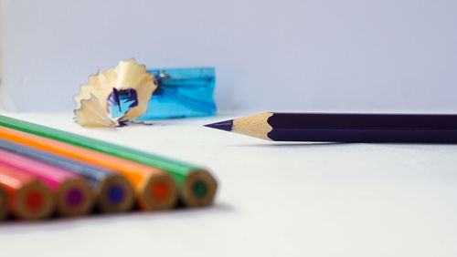 Close-up of multi colored pencils on table