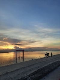 Scenic view of beach against sky during sunset