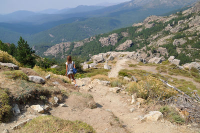 Rear view of woman looking at mountains