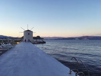 Traditional windmill against clear sky during sunset