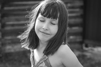 Summer portrait of a small pleased joyful girl.