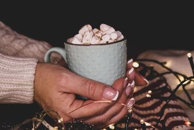 Woman holding cup of marshmallows