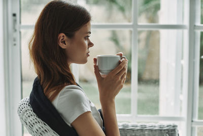 Young woman drinking coffee cup