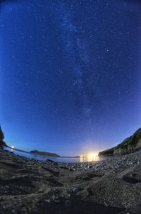 Scenic view of beach against sky at night