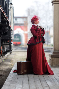 Low angle view of woman standing in city