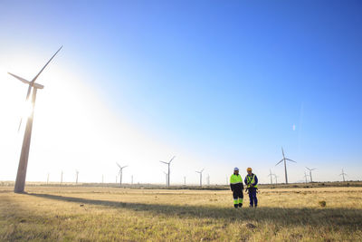 Two engineers discussing on a wind farm