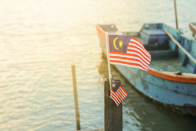 Flag on boat against sea