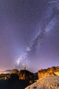 Scenic view of rocks against sky at night