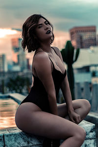 Woman looking at swimming pool in city