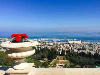 Aerial view of cityscape against blue sky 