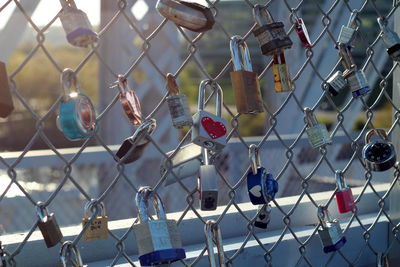 Close-up of padlocks on chainlink fence