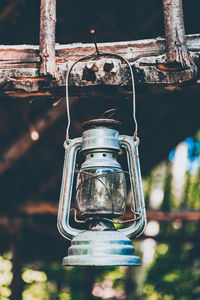 Low angle view of old lantern hanging at night