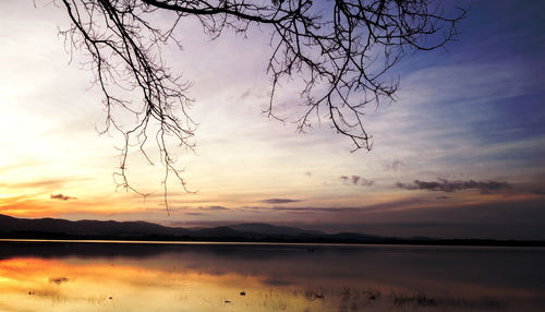 Scenic view of lake against sky during sunset