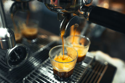 Close-up of drink pouring coffee in glass