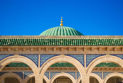 Low angle view of an islamic and arabic building against blue sky