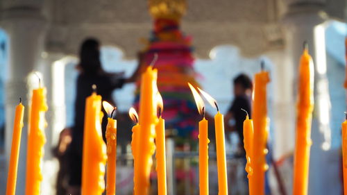 Close-up of lit candles in temple