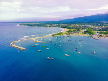 High angle view of boats in sea against sky