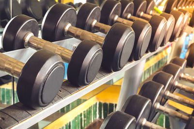 Close-up of dumbbells on racks