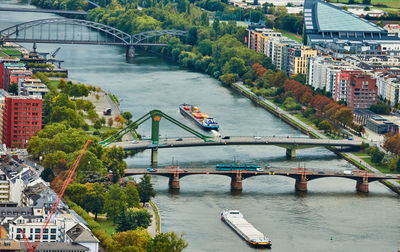 View from above of the bridges over the main river with freight ships carrying goods 