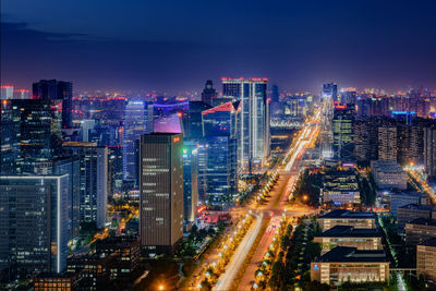 High angle view of city lit up at night