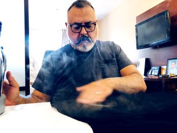 Man using mobile phone on table