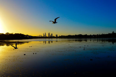 Lake monger reserve at sunset and perth skyline 