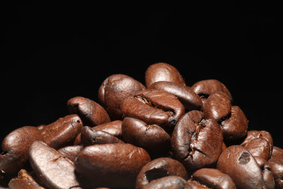 Close-up of coffee beans against black background