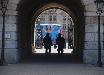 Rear view of people walking in building