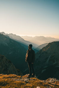 Man standing on mountain against sky