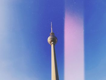 Low angle view of communications tower against sky