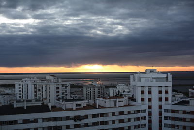 High angle view of buildings against dramatic sky