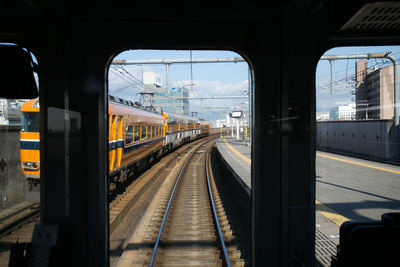 Railroad station platform seen through train window