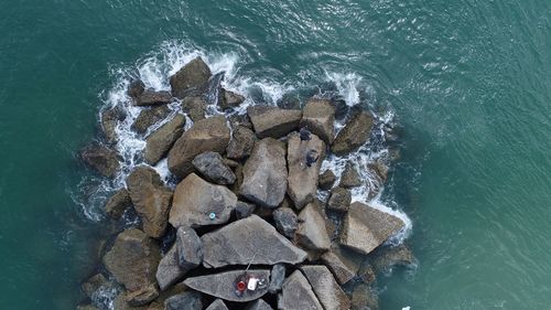 High angle view of rocks in sea