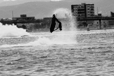 Full length of man riding jet boat in sea