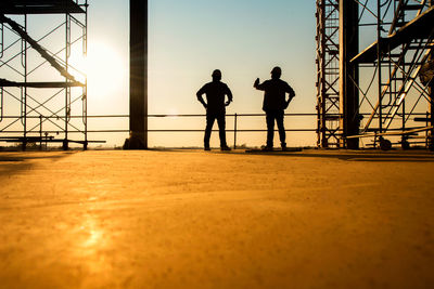 Silhouette men against clear sky