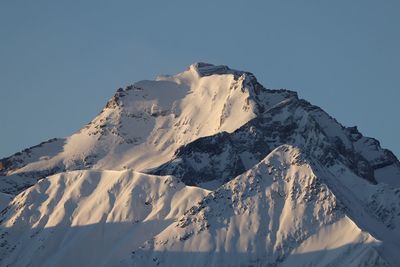 Scenic view of snowcapped mountains against clear sky