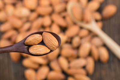 Close-up of almonds with spoon on table