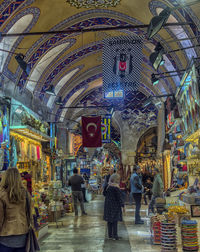 Rear view of people at illuminated market stall