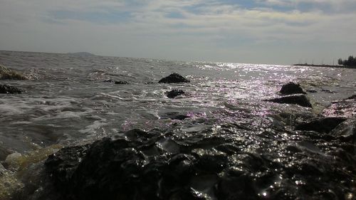 Scenic view of sea against cloudy sky