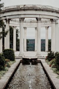 View of fountain in city against sky